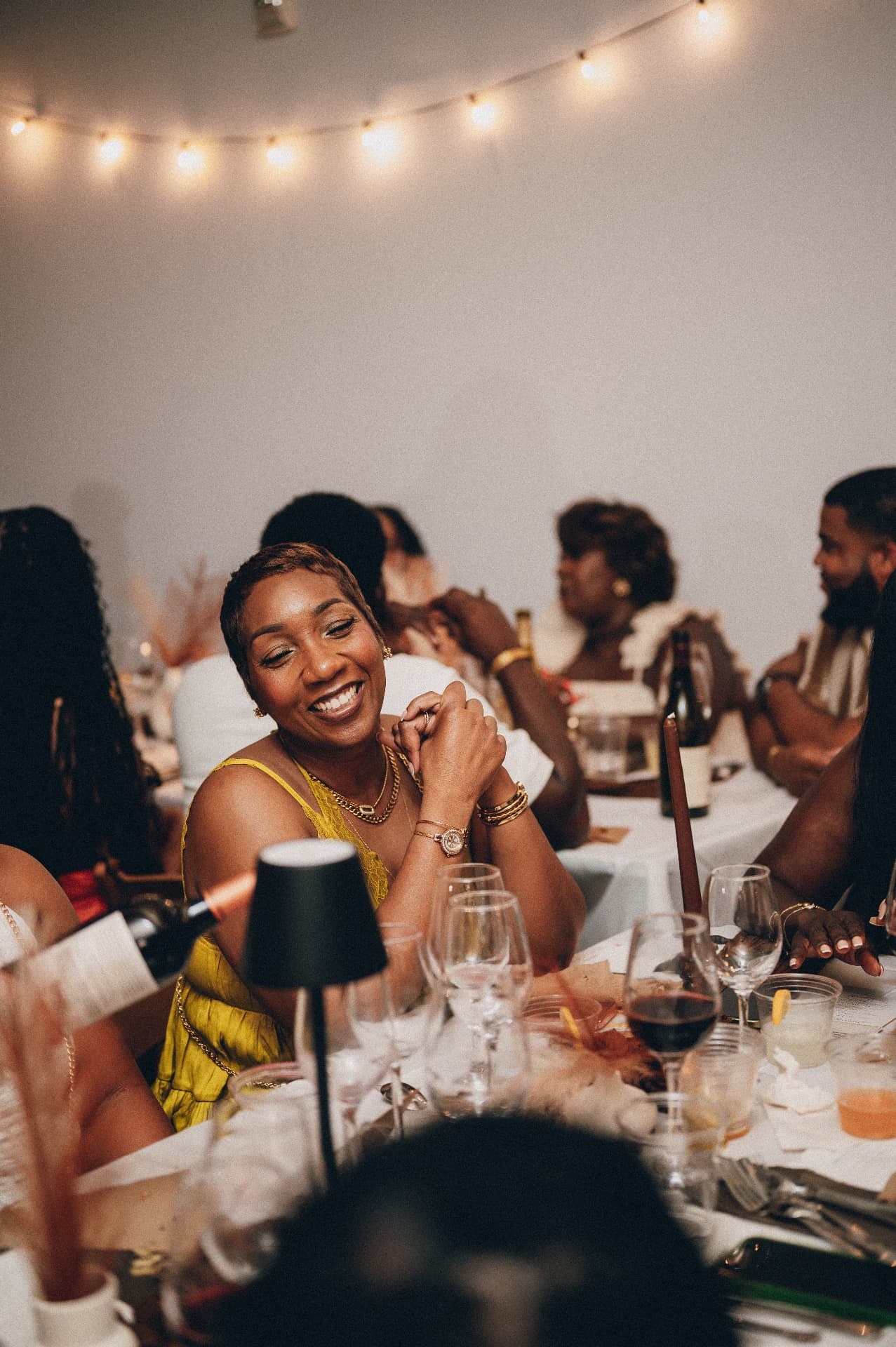 A guest smiling at the table during a Dirty Napkins supper club dinner